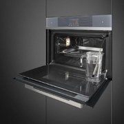 Компактный духовой шкаф с пароваркой Smeg SF4104WVCPS фото 2 в Казани и Татарстане